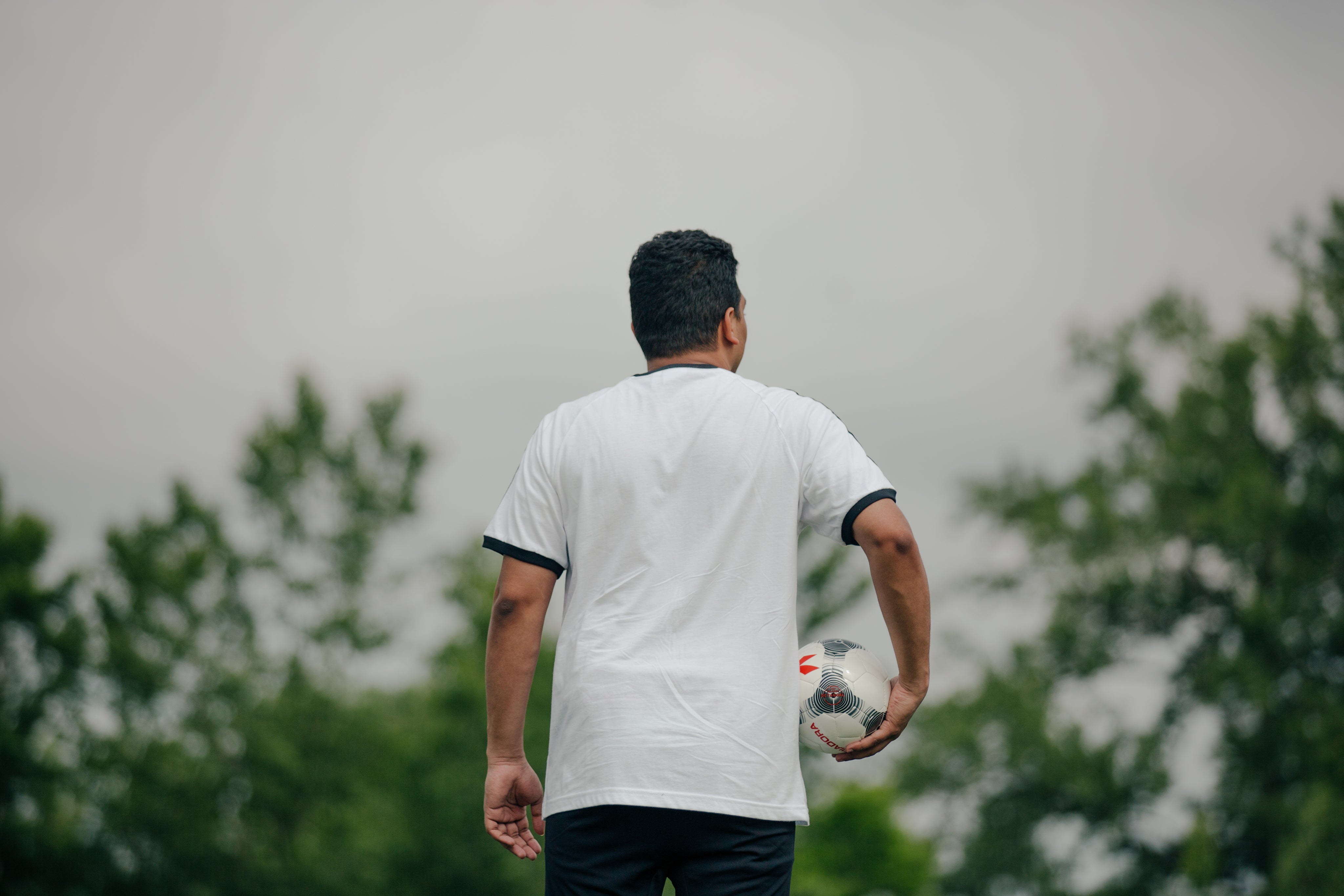 files/soccer-player-holding-ball-looking-out.jpg